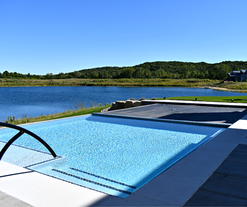 pool overlooking lake with pool cover