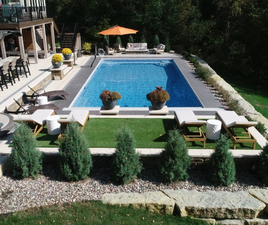 rectangular pool in backyard with landscaping